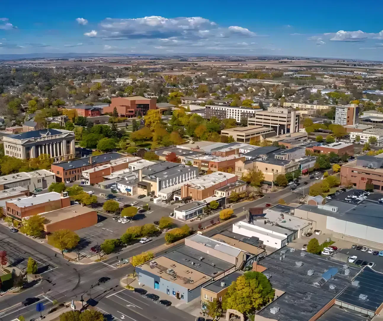 Aerial view of downtown Greeley, Colorado with local buildings and tree-lined streets