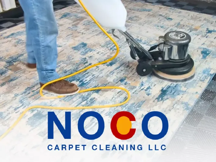 Technician using a floor buffer on an area rug for professional carpet cleaning service