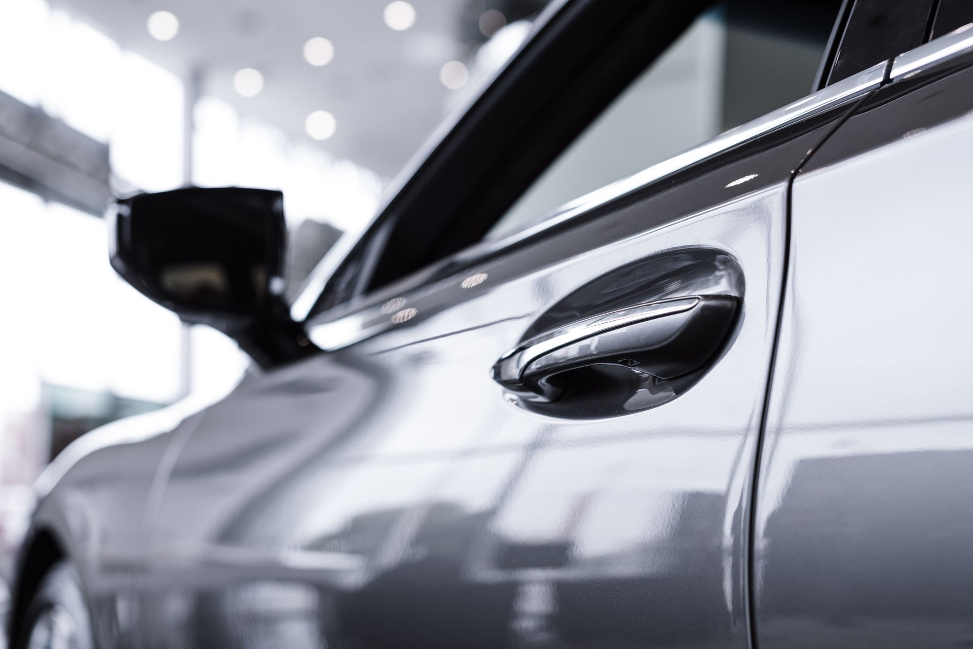 Close-up of shiny car at workshop after professional paint correction service.