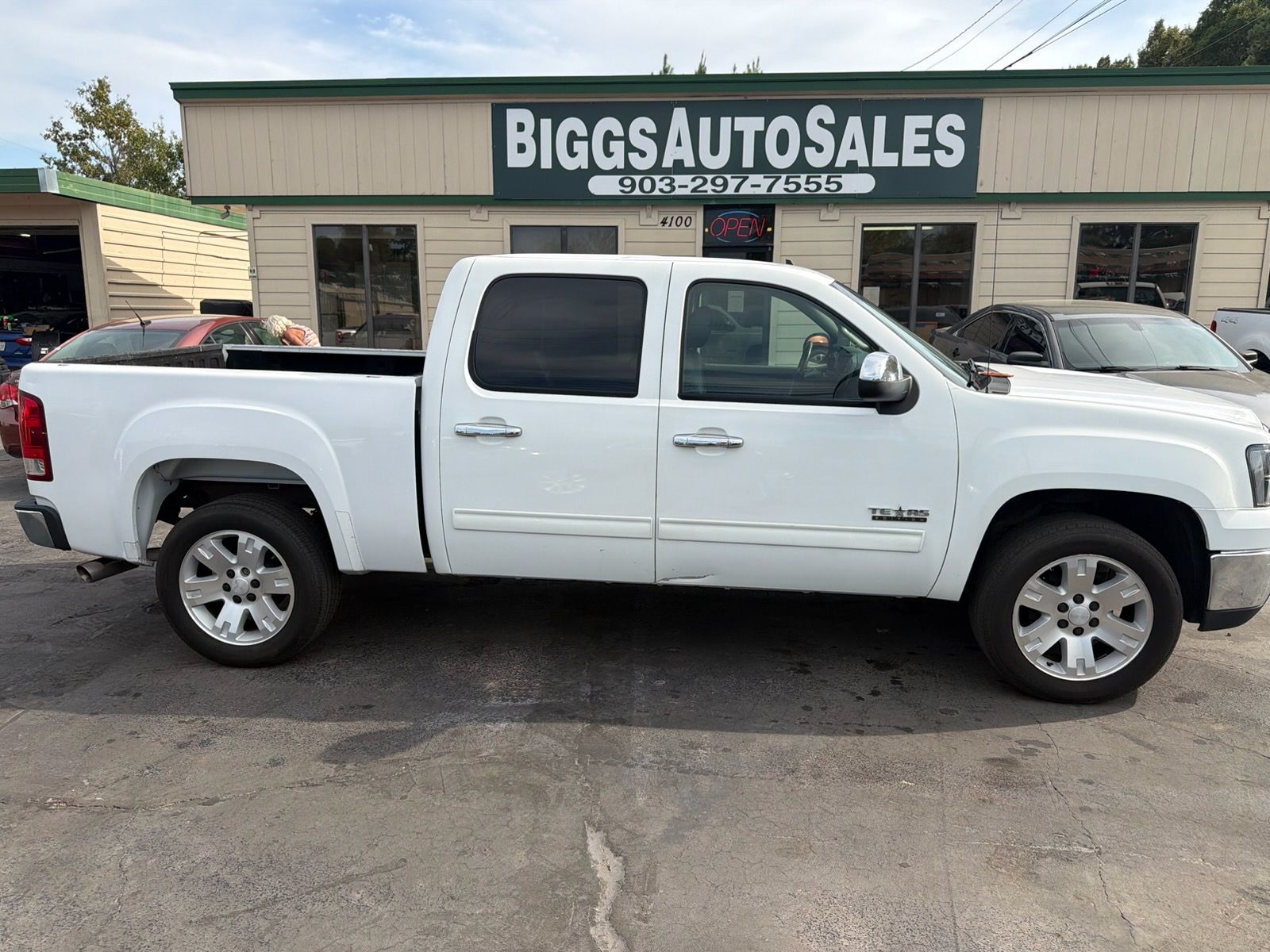 White pickup truck parked in front of Biggs Auto Sales dealership