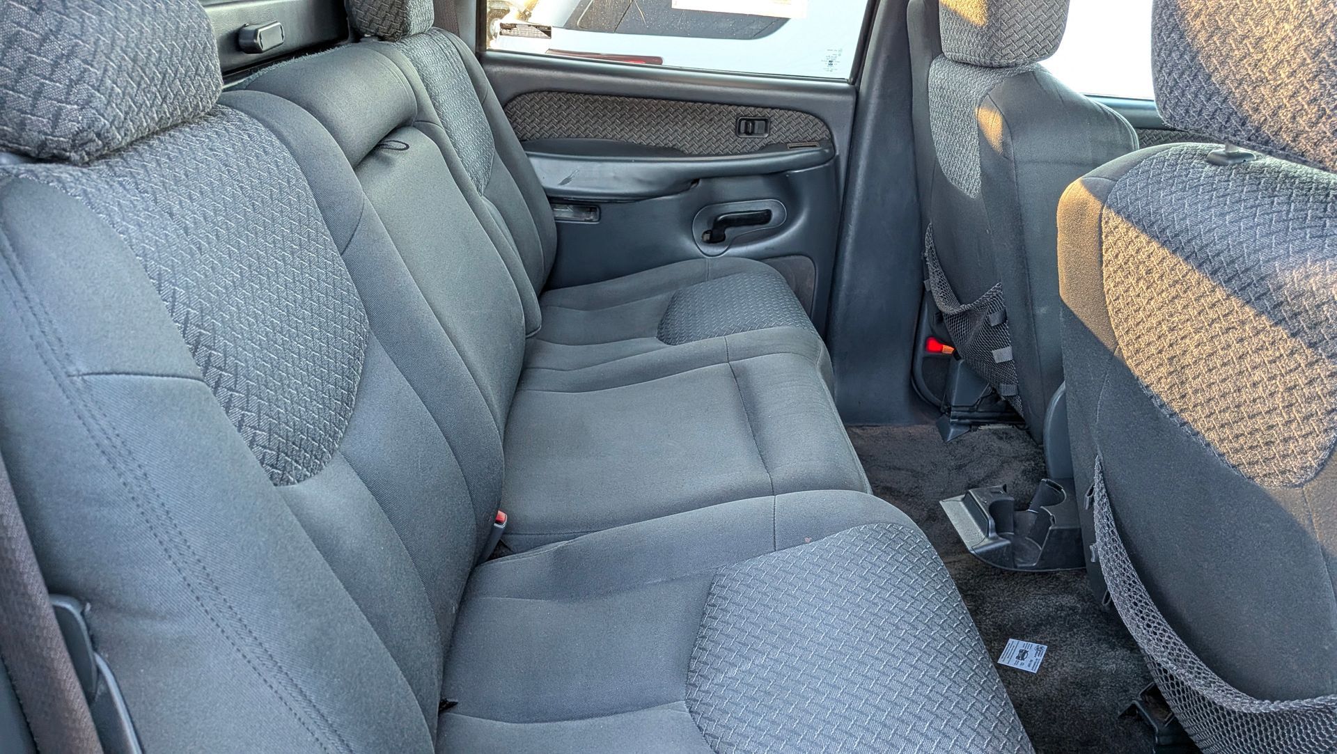 Gray truck backseat with patterned fabric.