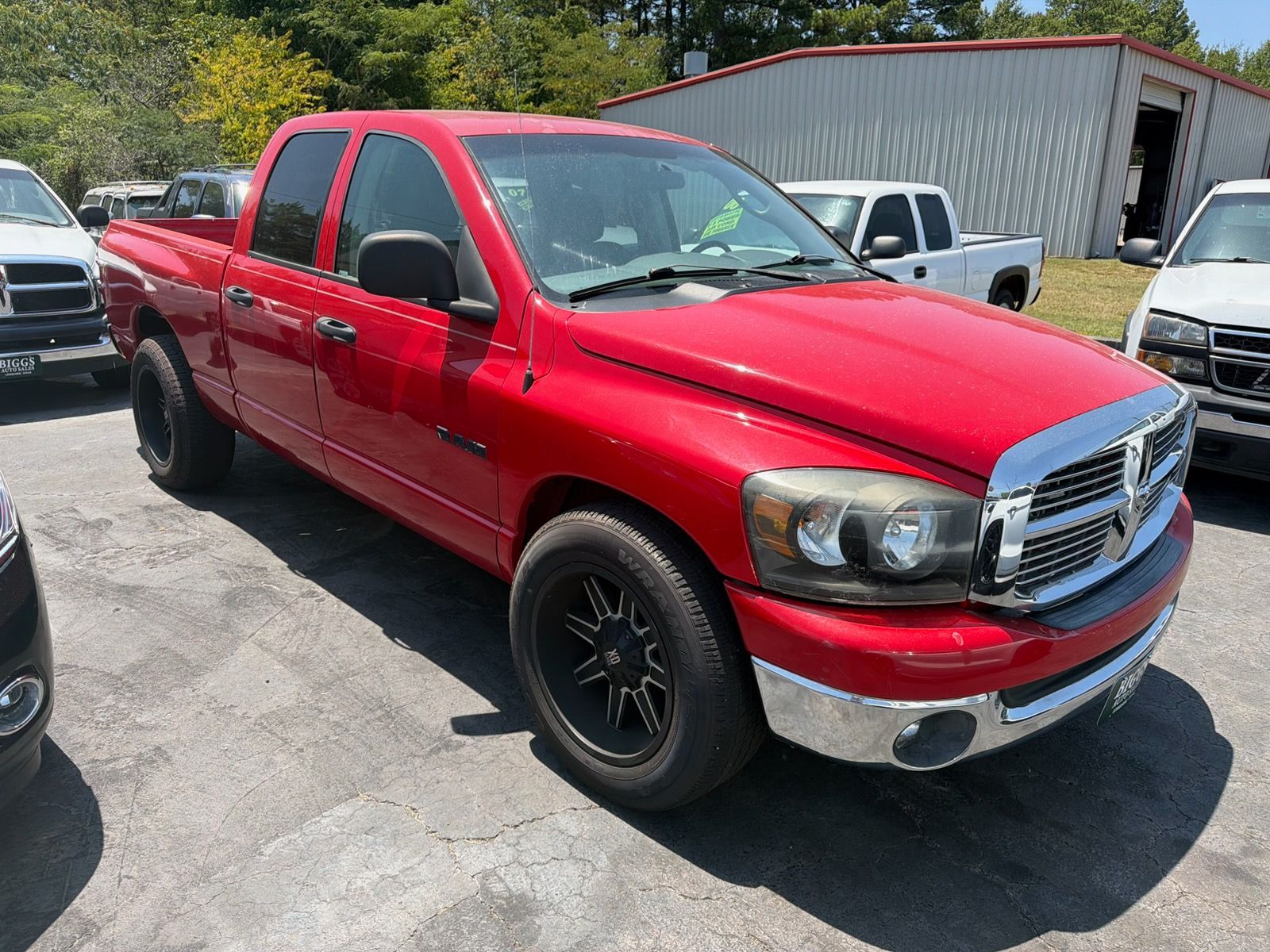 Red pickup truck parked outdoors in a lot, shown from the front-left side.