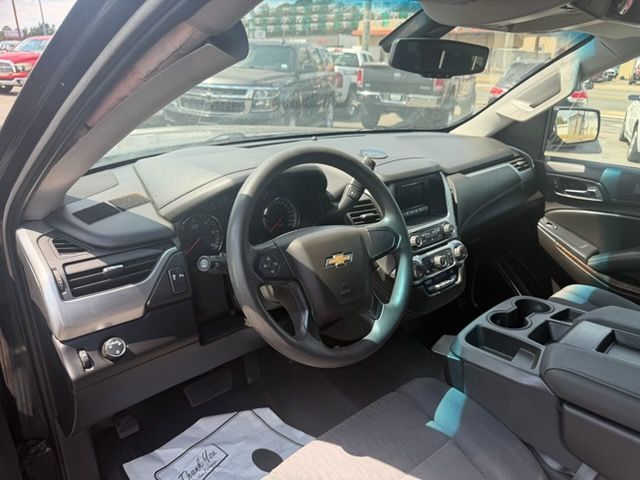 Car interior view of a black Chevrolet dashboard, steering wheel, and center console from the driver’s seat.