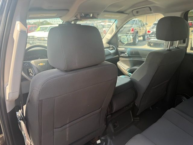 Interior of a car, showing the back seat and front seat headrests from the rear passenger area.