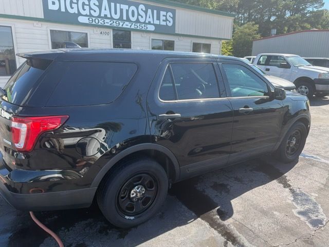 Black SUV with rear damage parked at Biggs Auto Sales lot