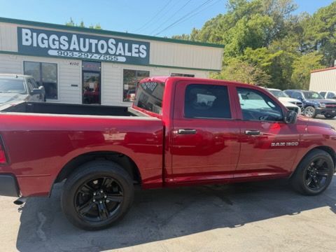 Red pickup truck parked outside Biggs Auto Sales dealership