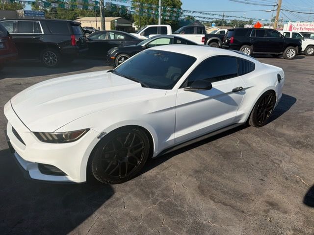 White sports coupe parked in a lot, viewed from the front-left side