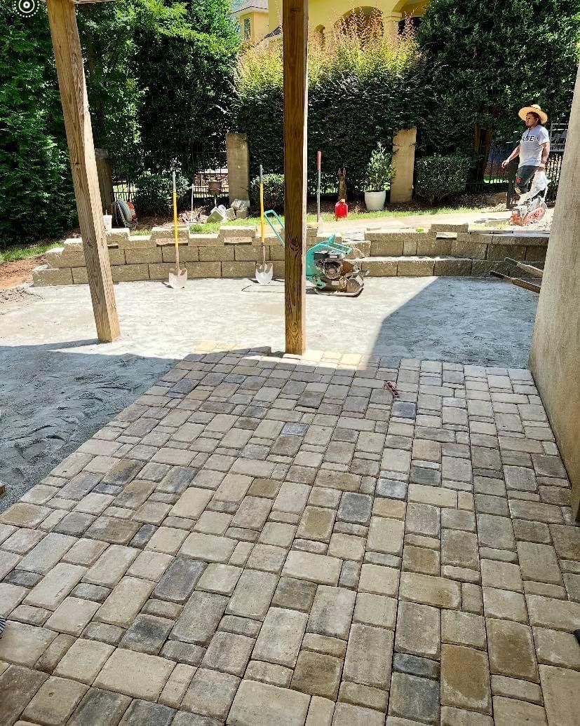 A patio is being built in a backyard.