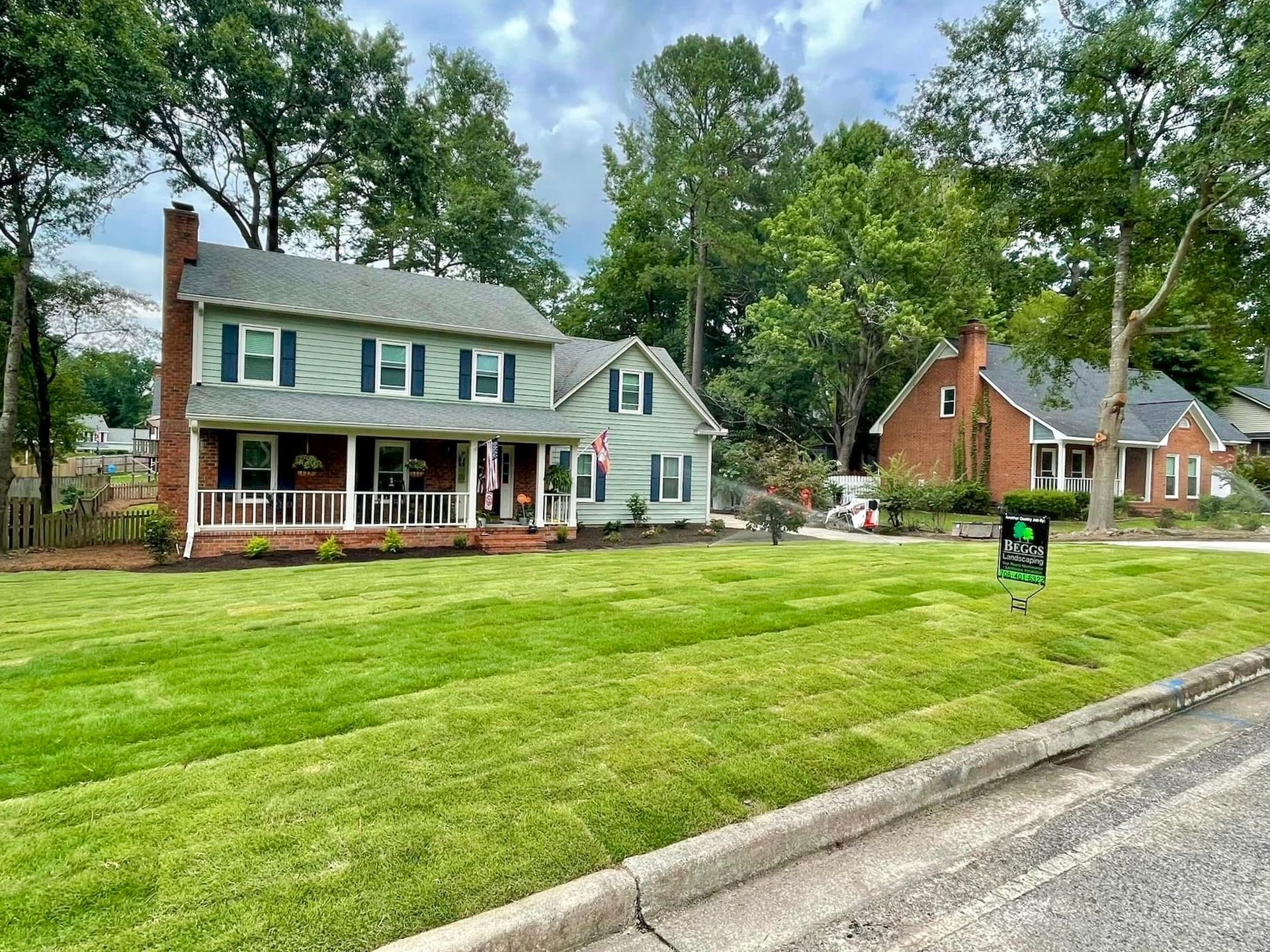 A large house with a lush green lawn in front of it.