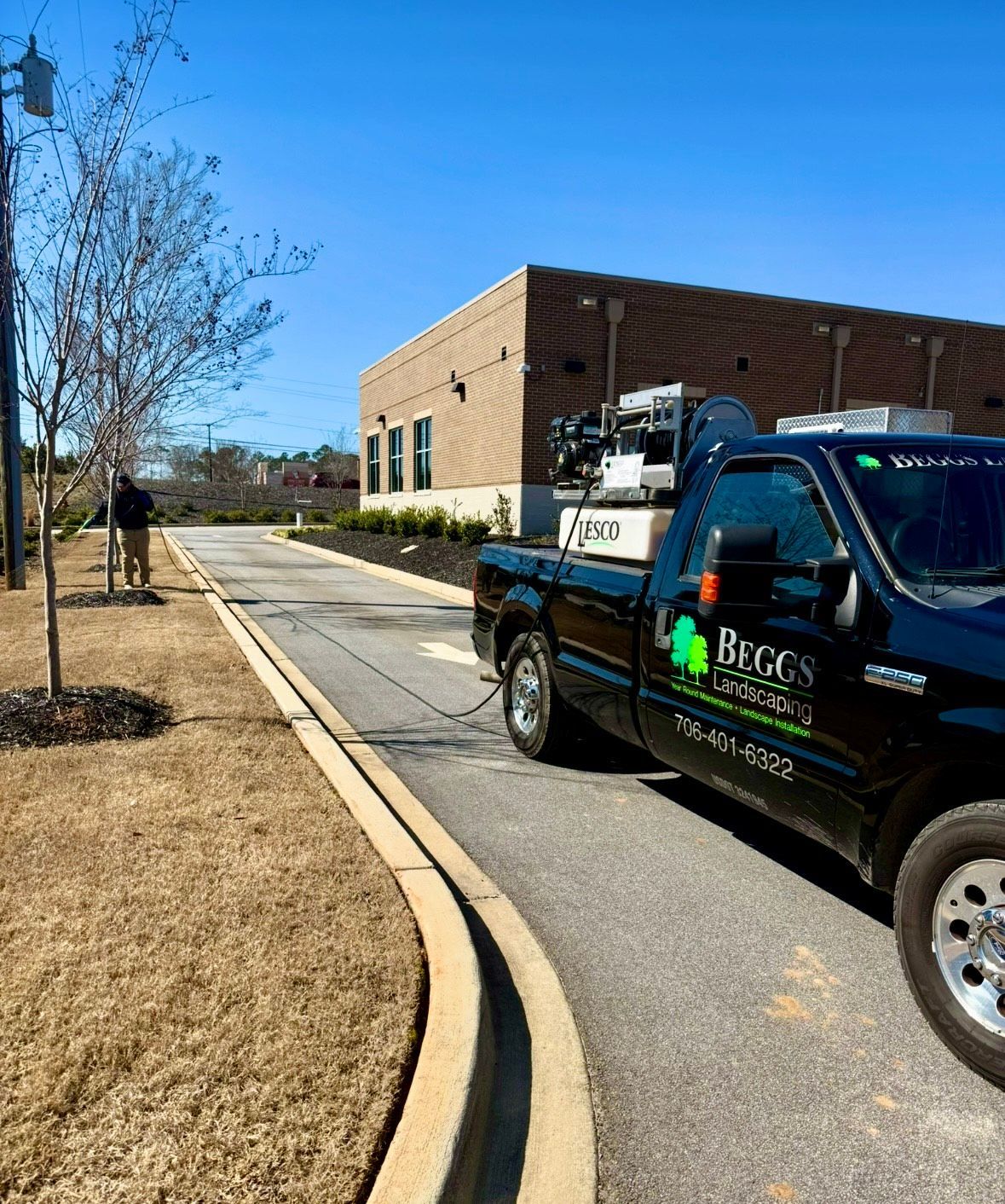 A black pickup truck from 'Begg's Specialties' parked next to a building.