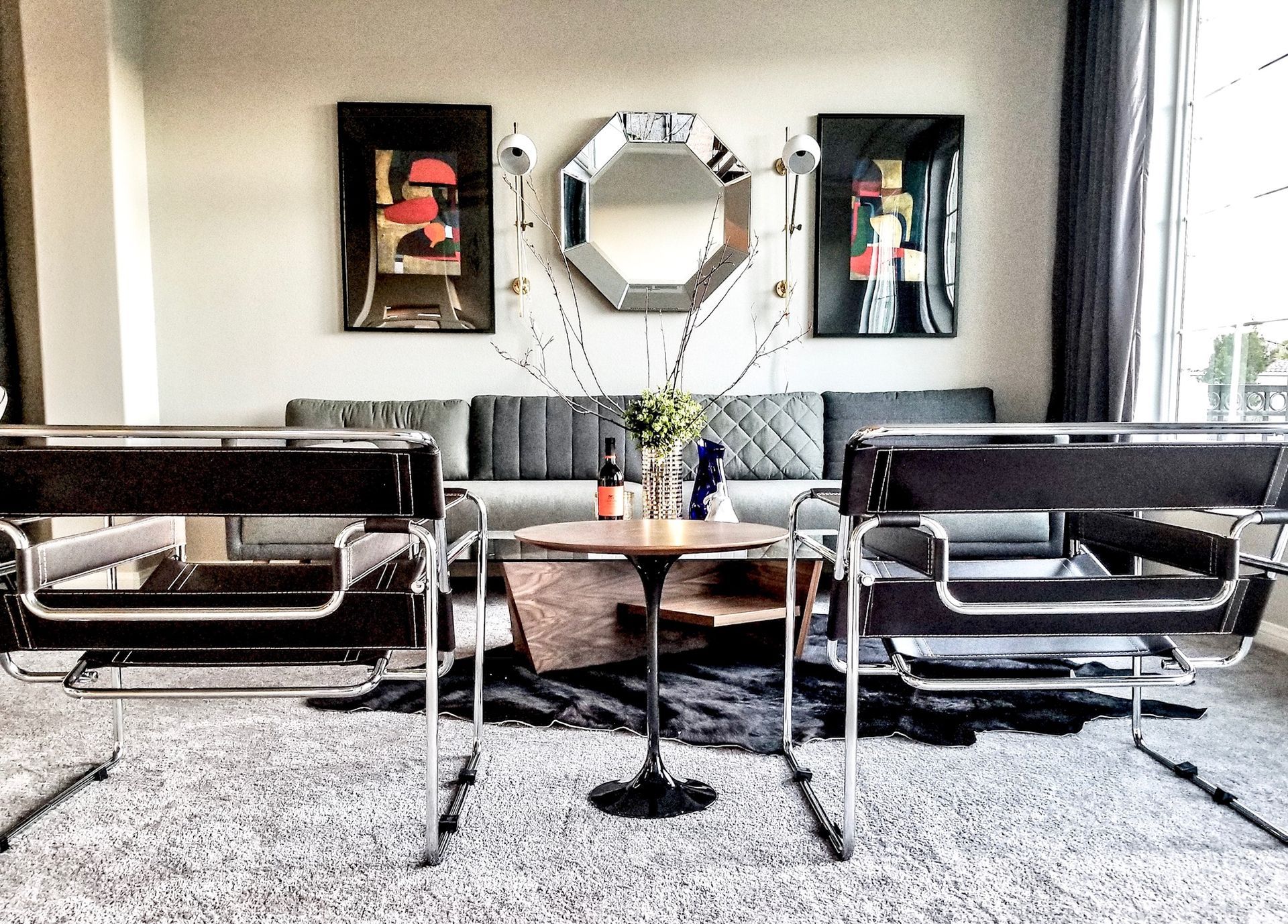 Modern living room with brown sectional sofa, coffee table, TV, and large floral wall art