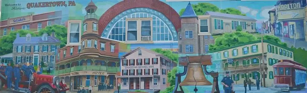 Colorful mural of a school building with a red arch, clock tower, and people in front.
