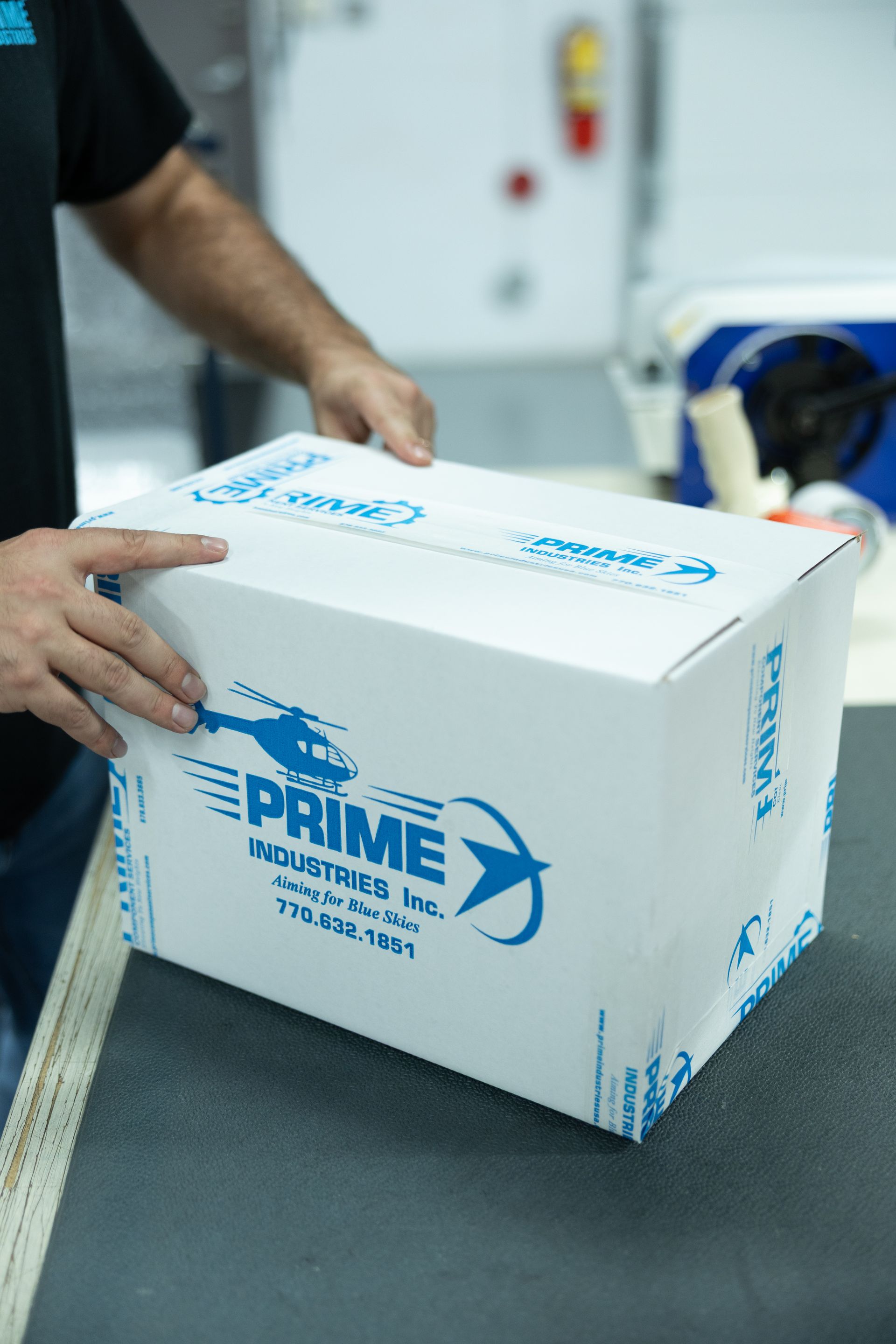 Person holding a white box labeled 