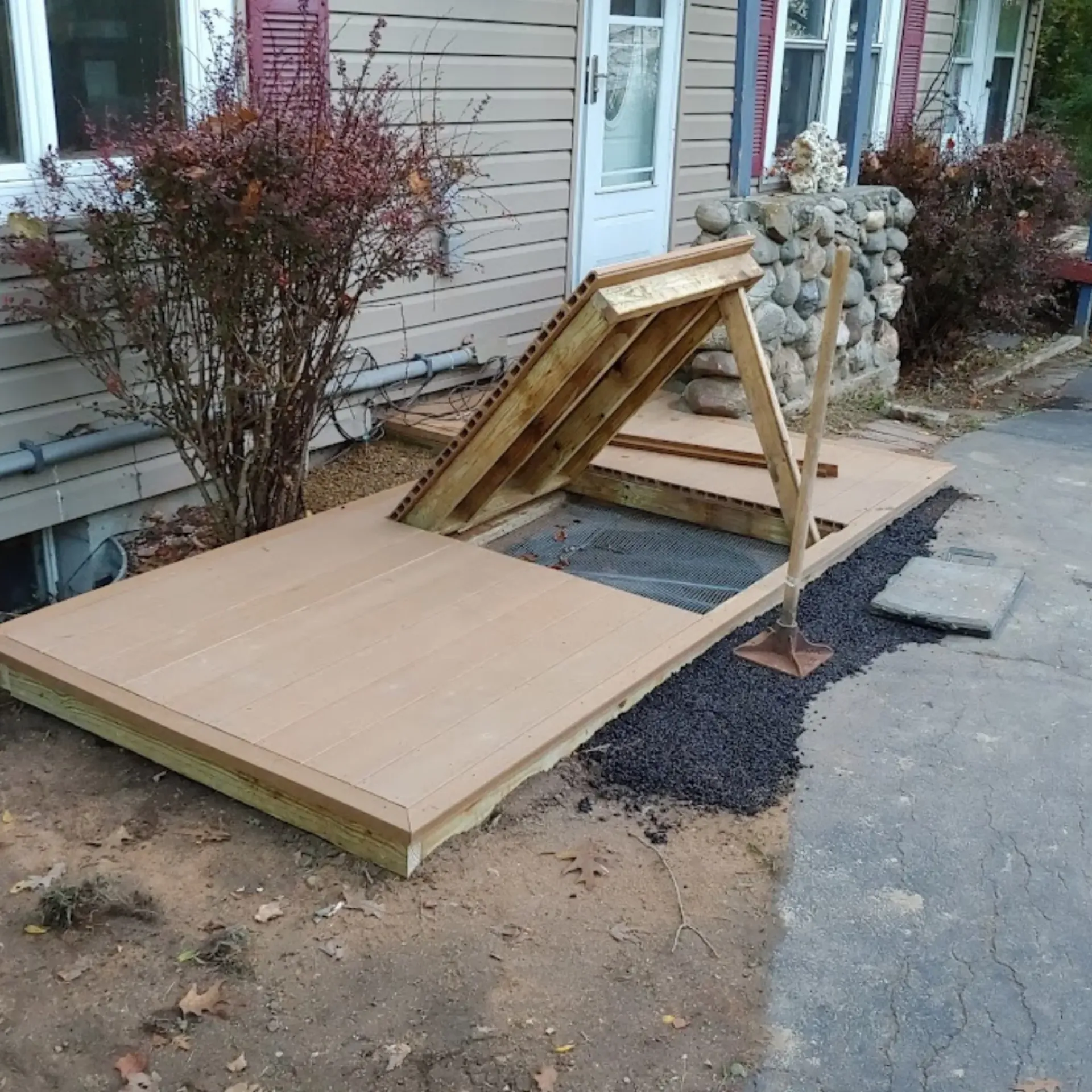 CK Maintenance LLC - A wooden deck is being built in front of a house