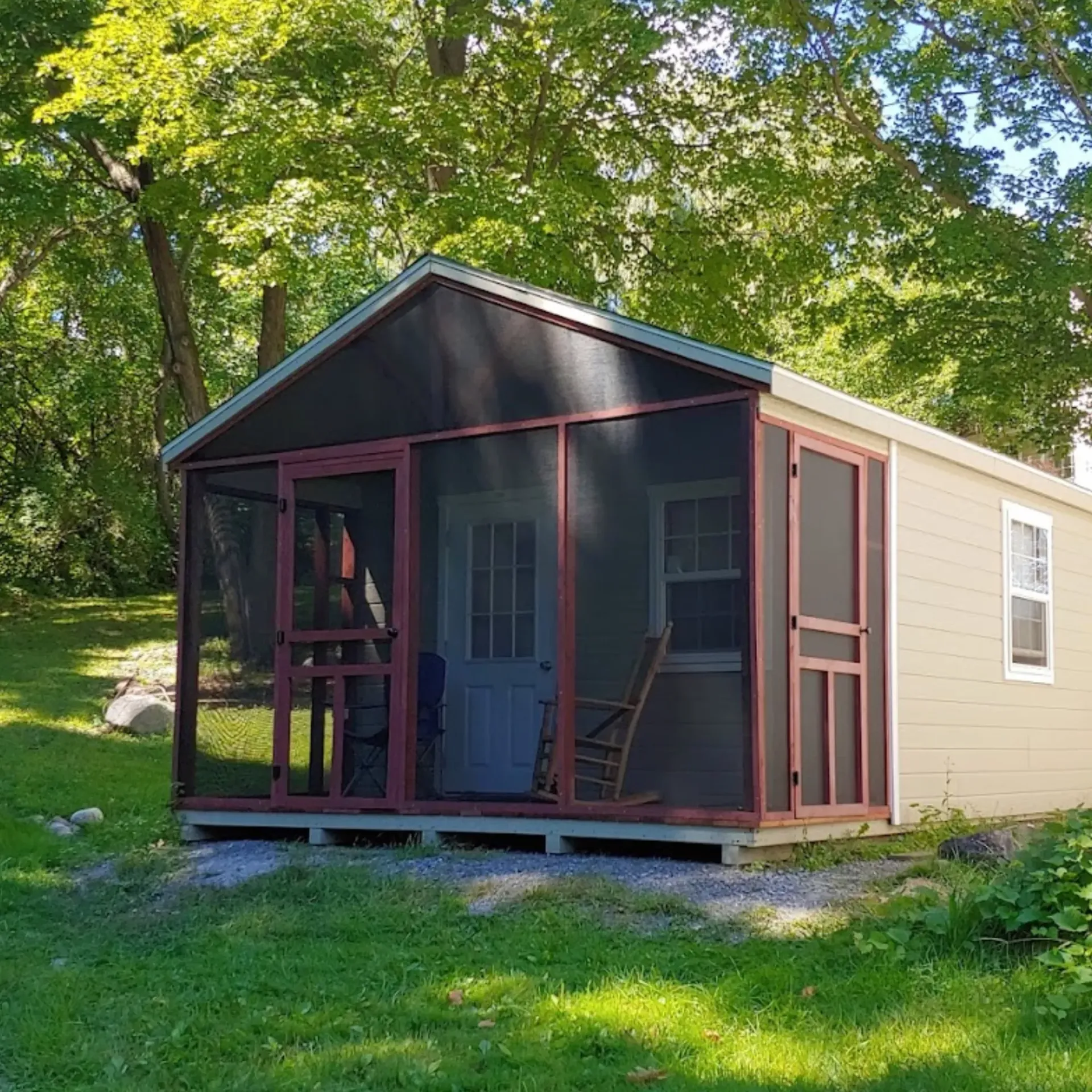 CK Maintenance LLC - A small house with a screened in porch and rocking chairs.