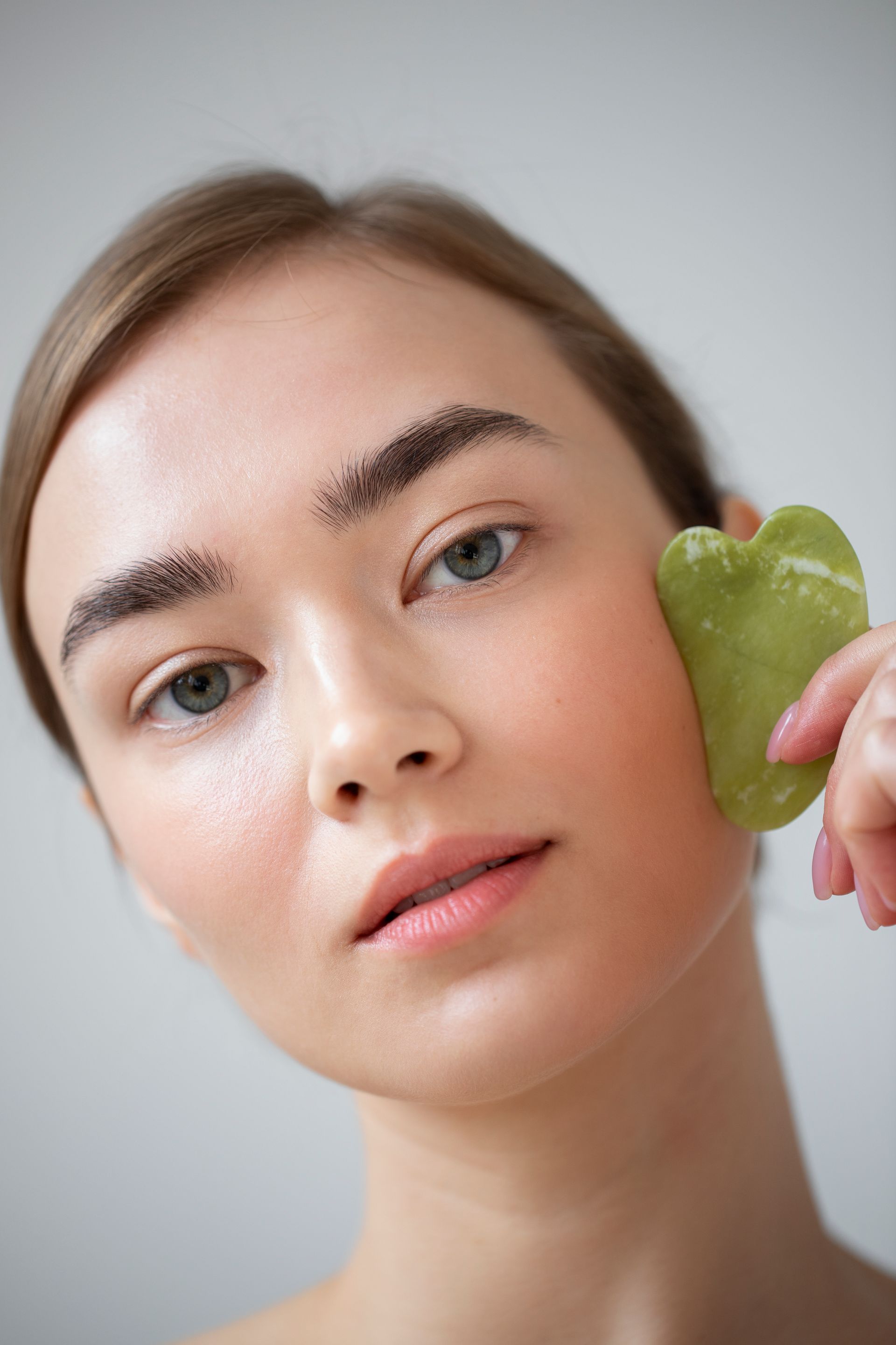 woman using gua sha