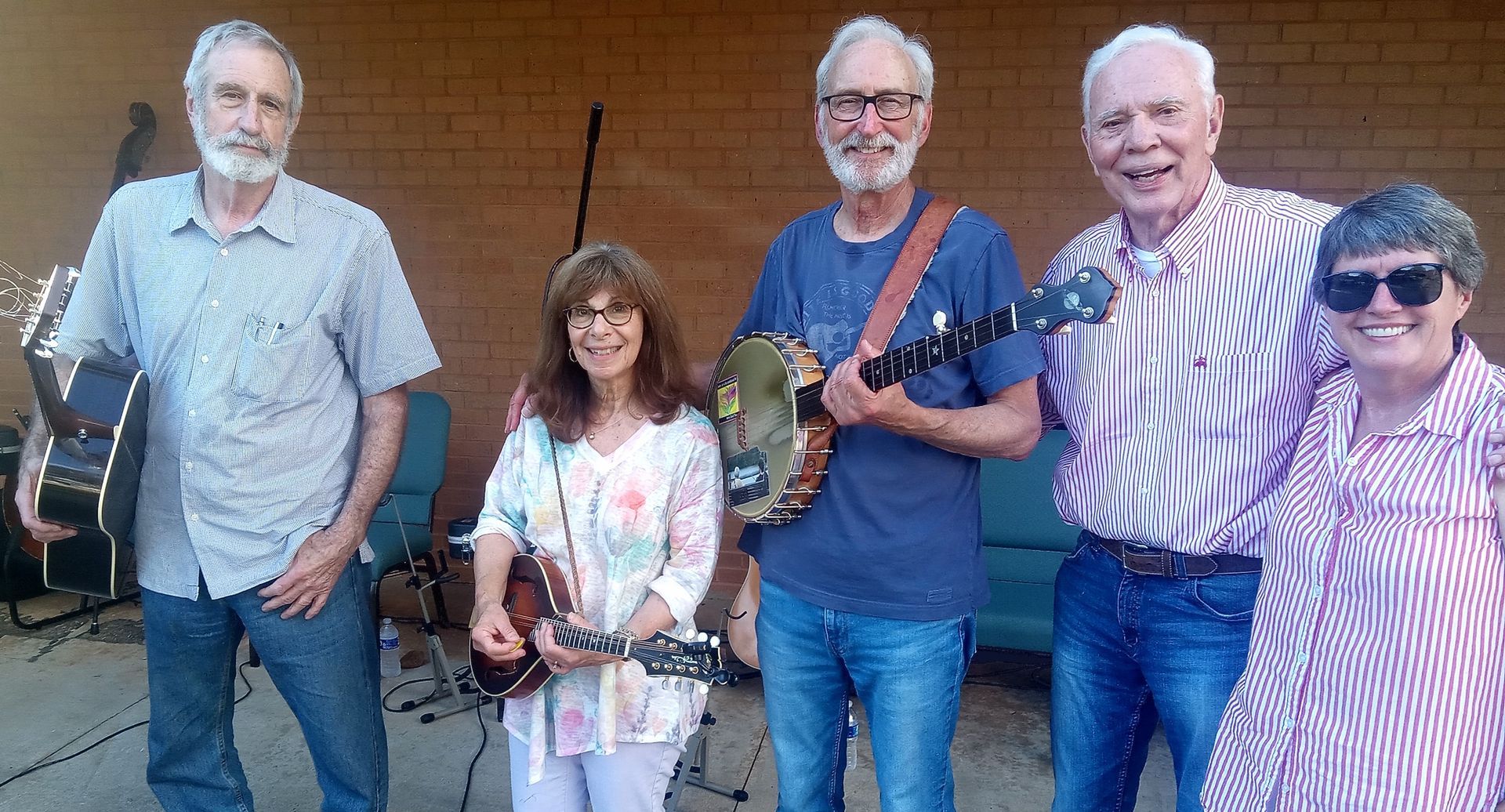 A group of people standing next to each other holding musical instruments.
