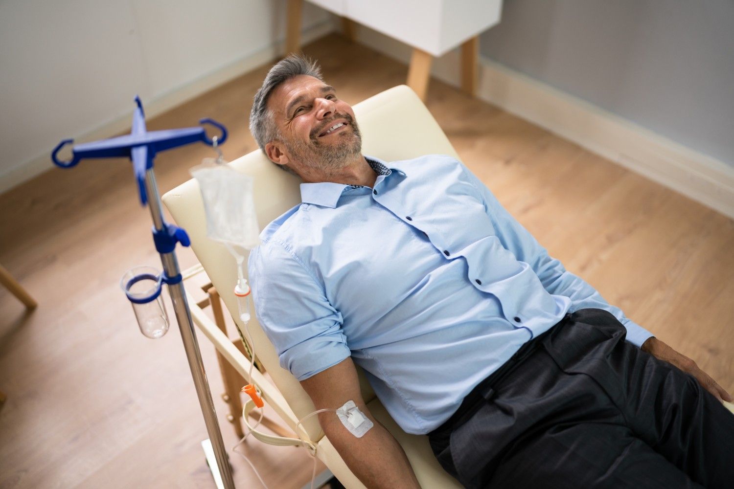 a man is laying in a chair with an iv in his arm
