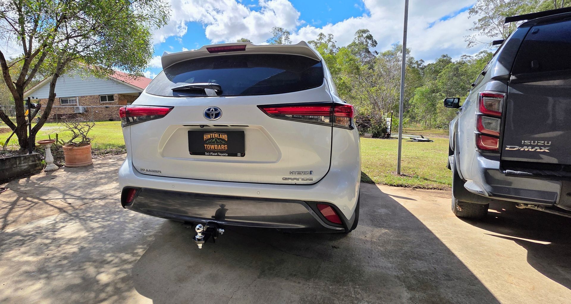 White Proton X70 SUV Parked Under A Carport, Rear View With License Plate Obscured — Hinterland Towbars in North Sunshine Coast, QLD