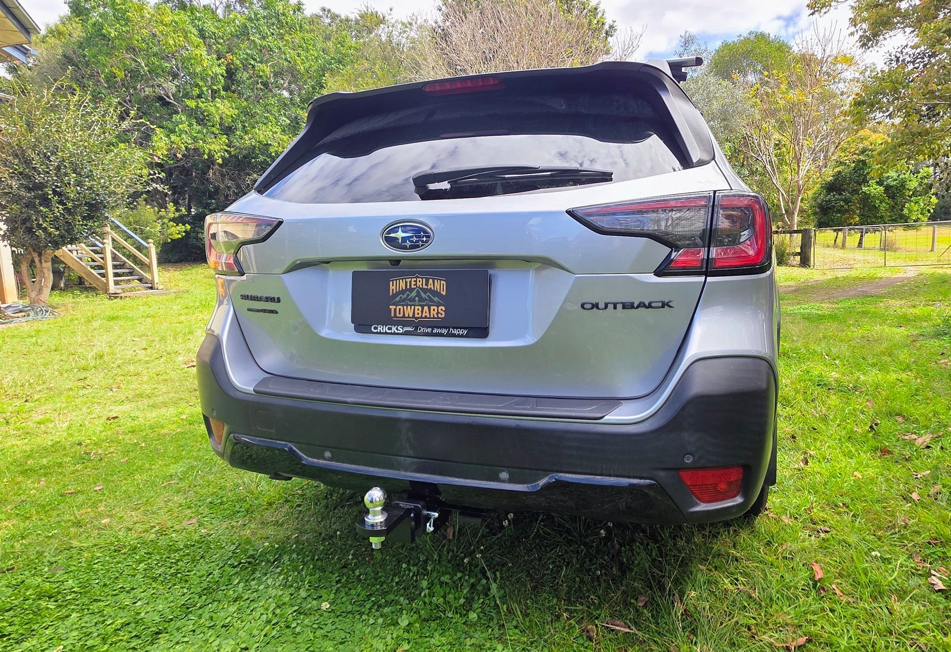 Silver Suv Parked on Grass, Rear View with Tow Hitch and Trees in The Background — Hinterland Towbars in Southside, QLD