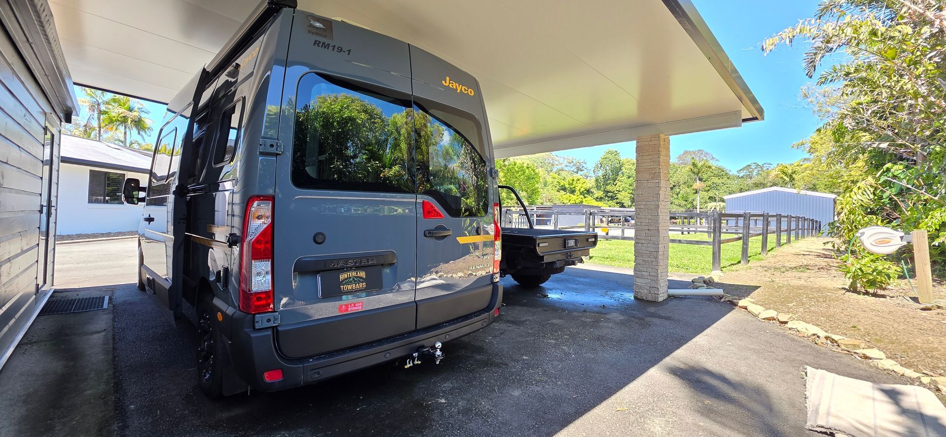 Black Van Parked Under a Canopy Beside a Driveway — Hinterland Towbars in Noosa, QLD