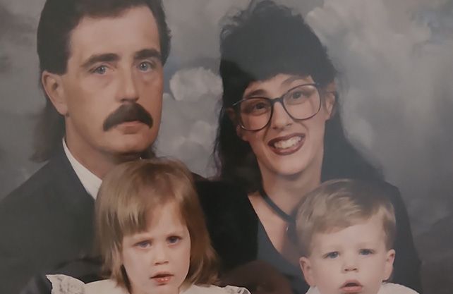 Family portrait: adults with dark hair and mustaches, children with blond hair.