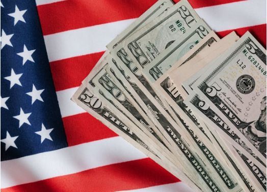 American flag with a fan of US dollar bills.