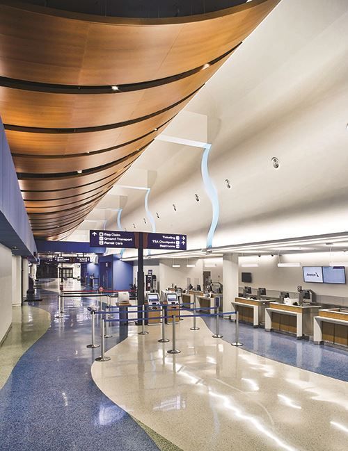 A long hallway with a sign that says ' departures ' on it