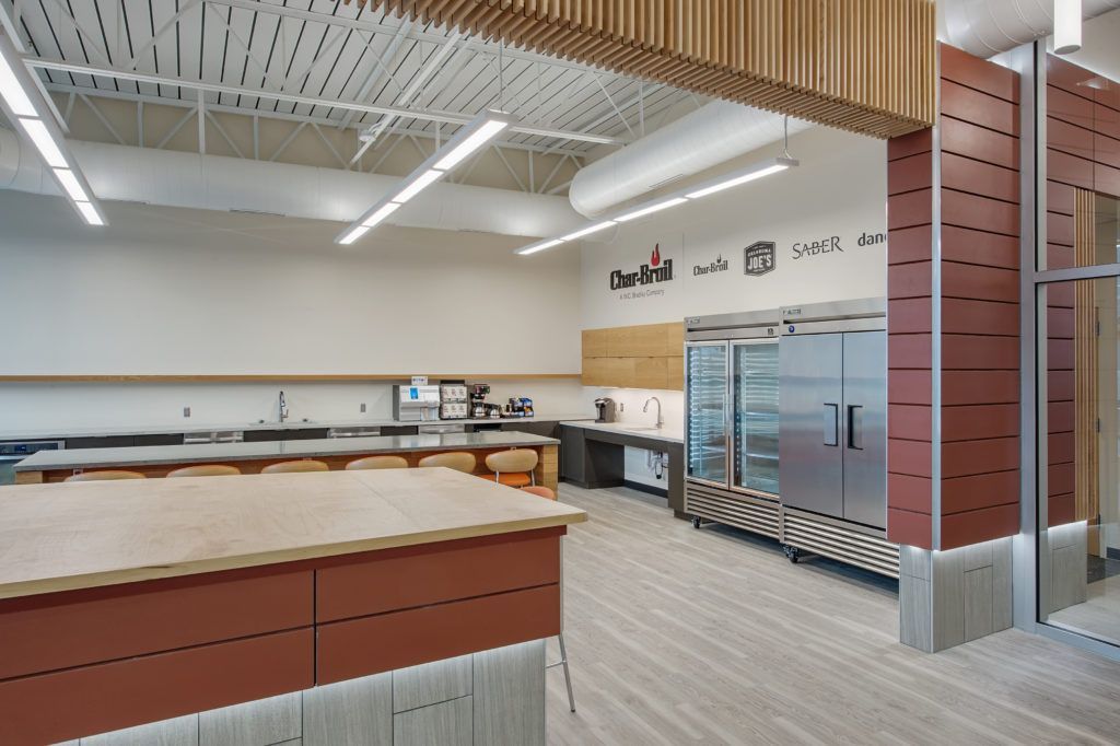 A kitchen with a large counter and a refrigerator.
