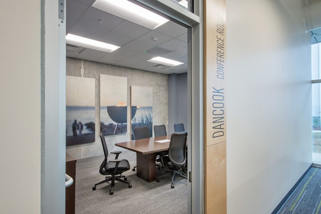 A conference room with a table and chairs in an office building.