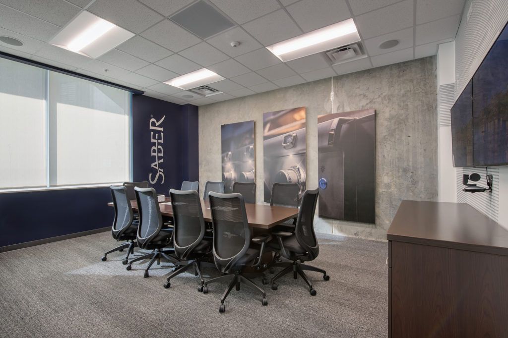 A conference room with a long table and chairs.