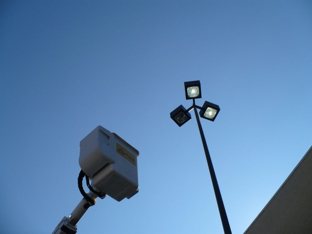 Looking up at a street light with a blue sky in the background