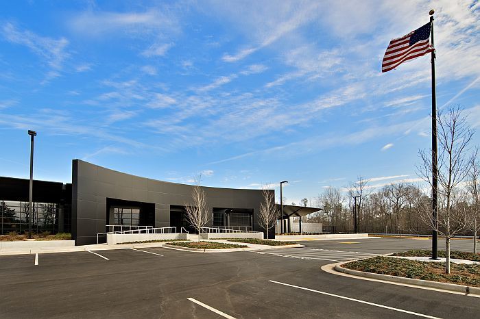 An american flag is flying in front of a building.