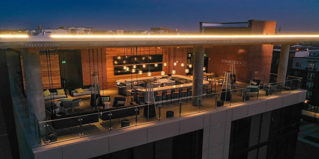 An aerial view of a restaurant on the roof of a building at night.