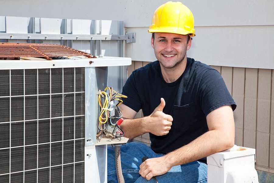 a man giving a thumbs up next to an air conditioner