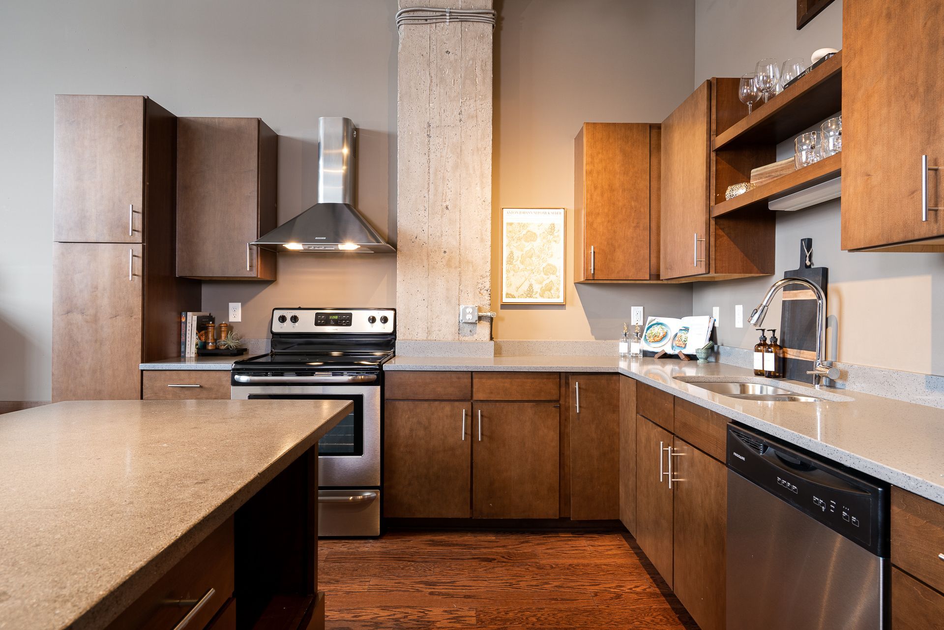 A kitchen with stainless steel appliances and wooden cabinets