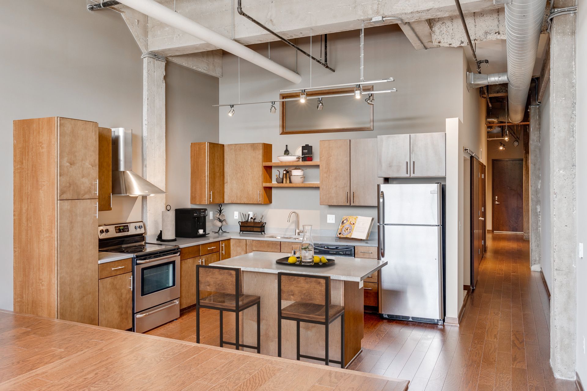A kitchen with stainless steel appliances and wooden cabinets