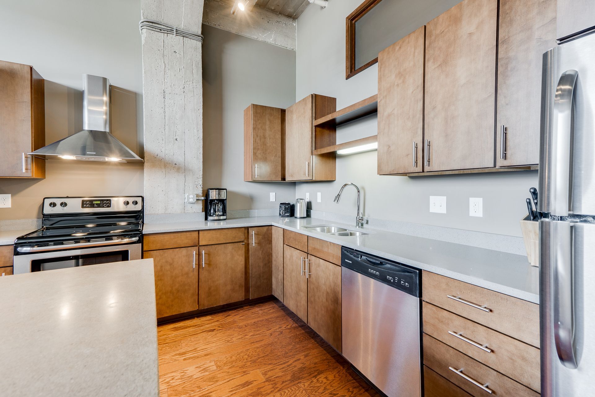 A kitchen with stainless steel appliances and wooden cabinets