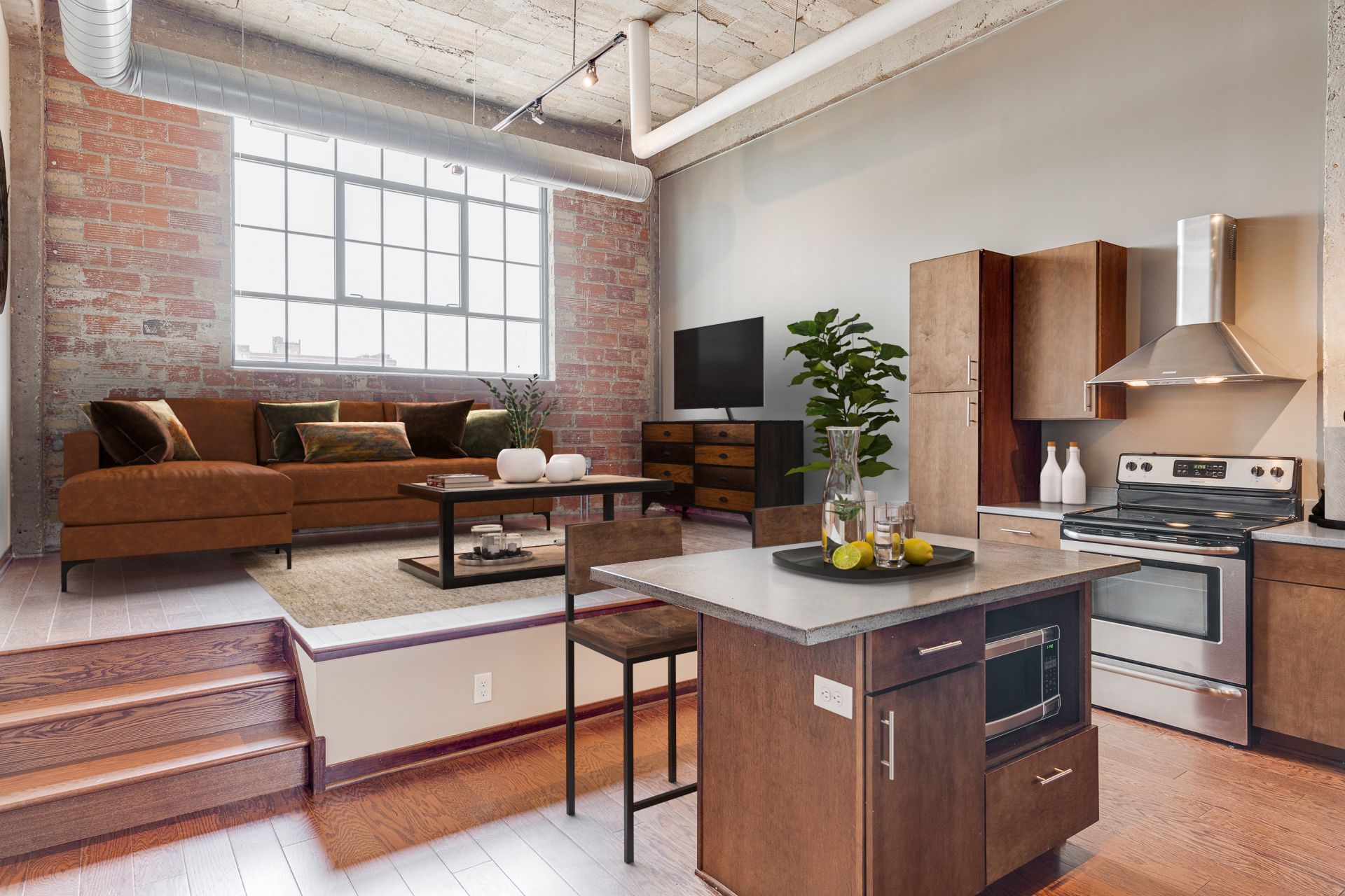 An artist 's impression of a living room and kitchen in a loft apartment.