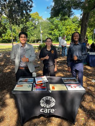 Uptown Connect teammates representing CARE at an outdoor outreach table