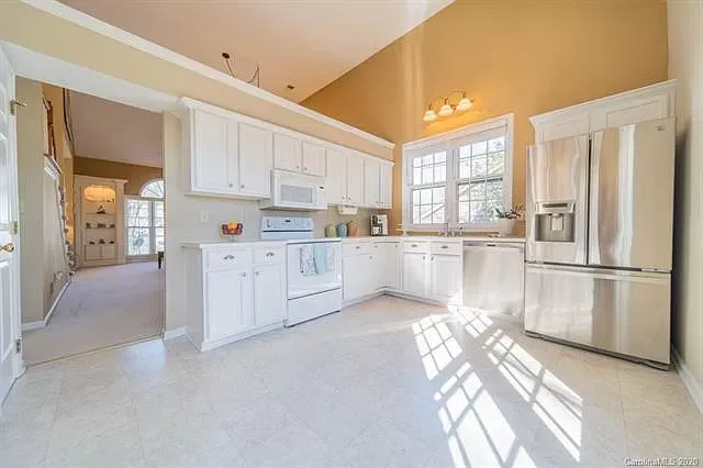 A kitchen with white cabinets and stainless steel appliances.