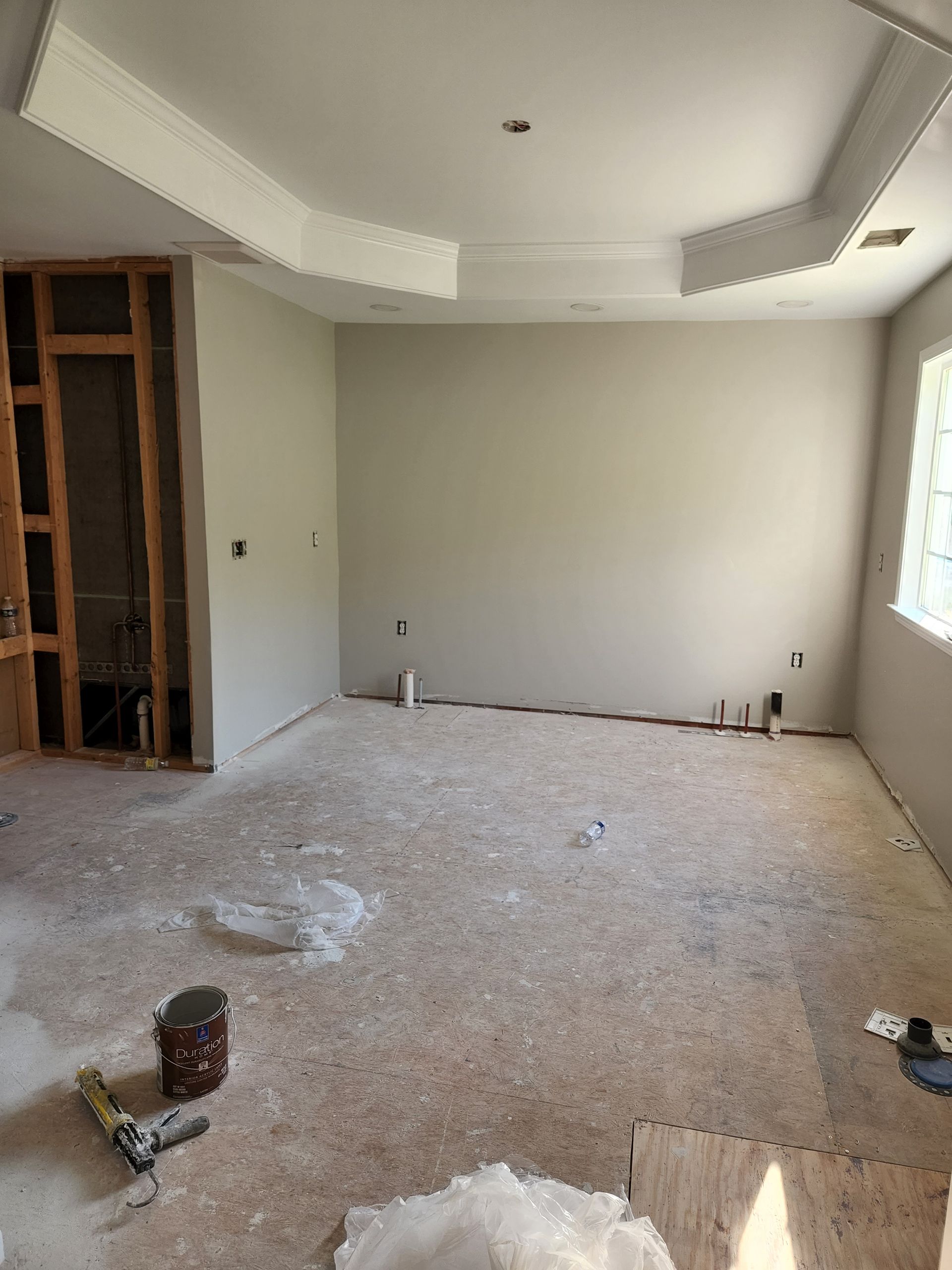 A large empty room with a ceiling that is being remodeled.