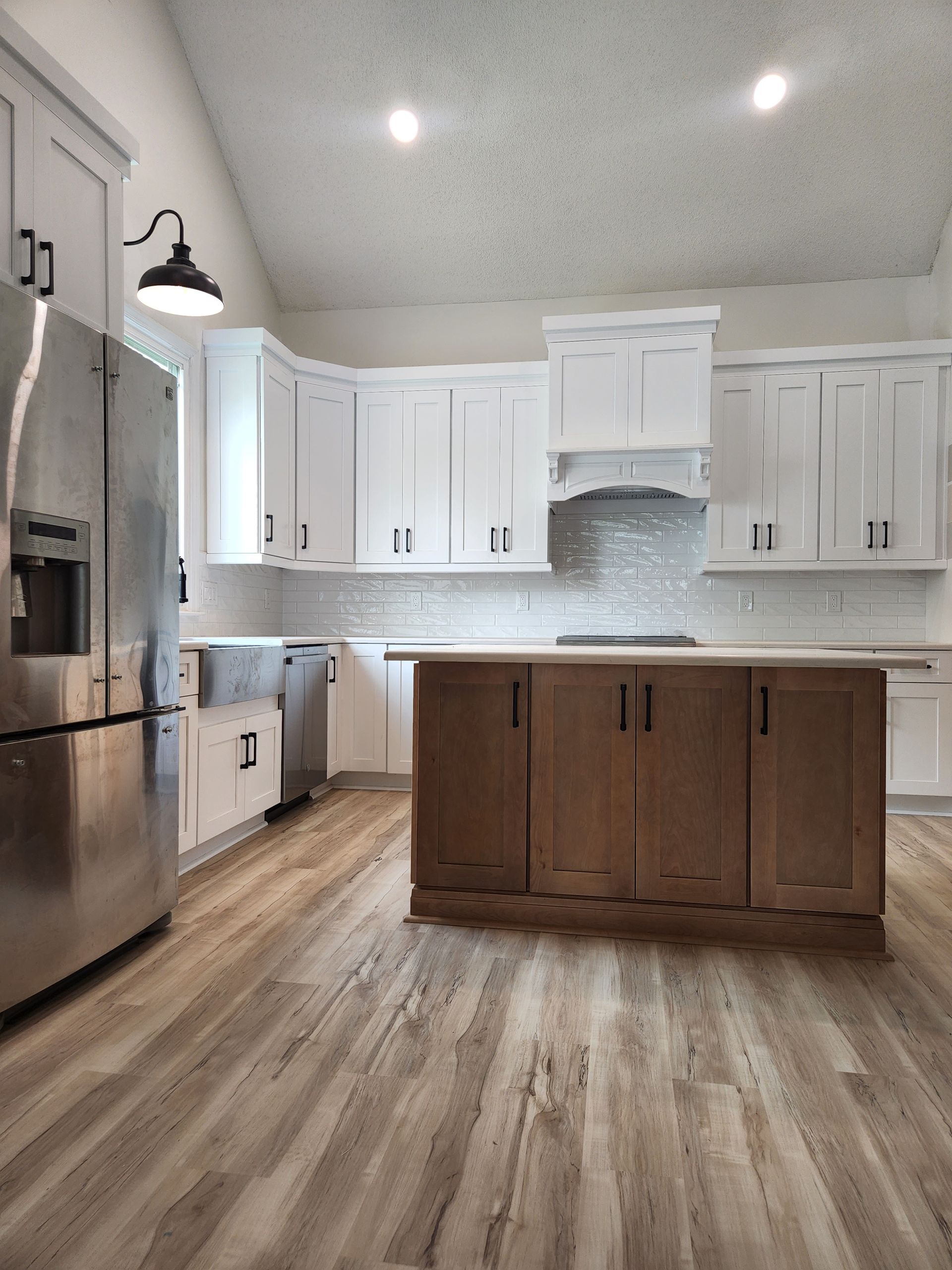 A kitchen with stainless steel appliances and wooden cabinets