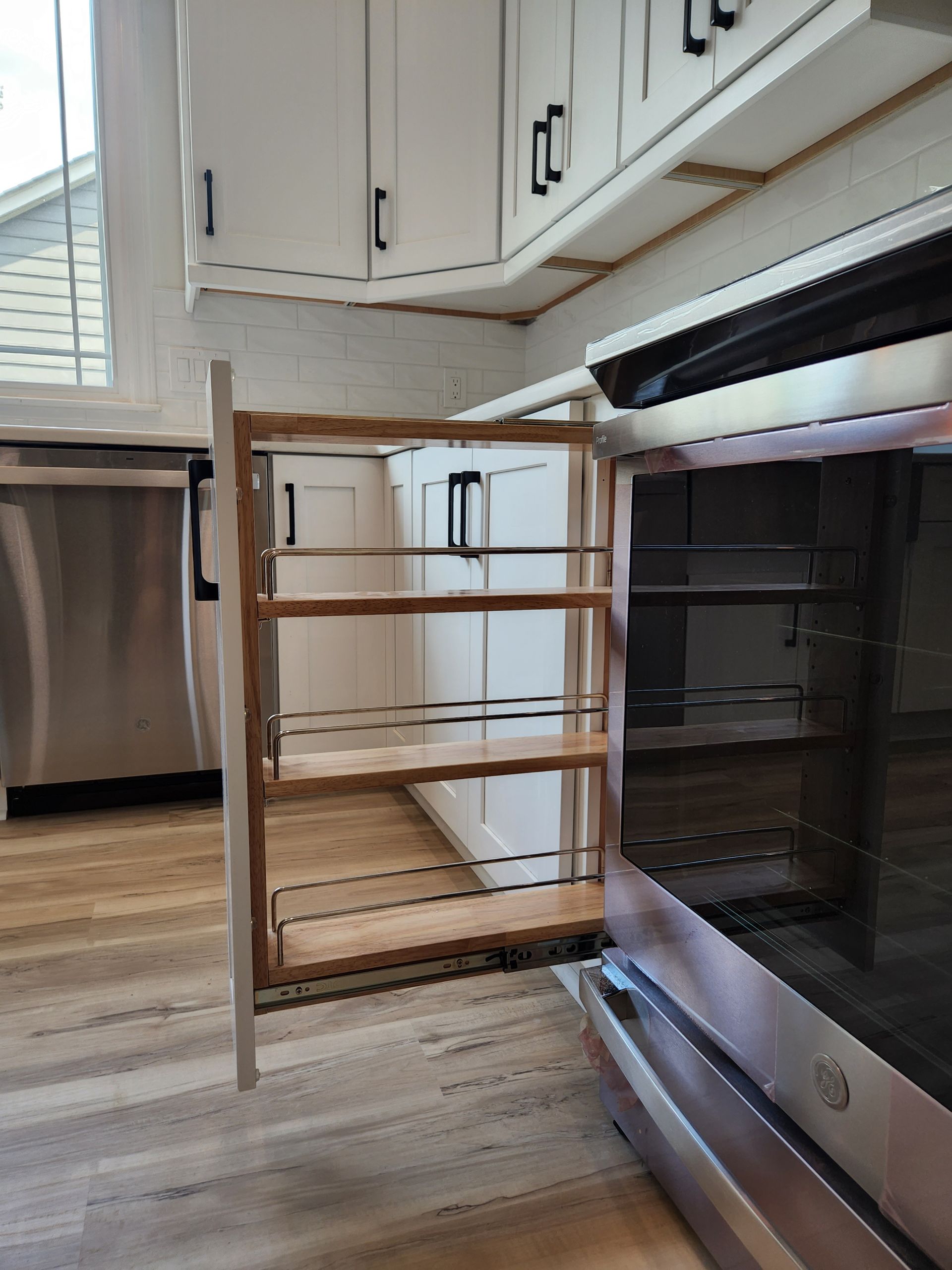 A kitchen with stainless steel appliances and wooden cabinets.