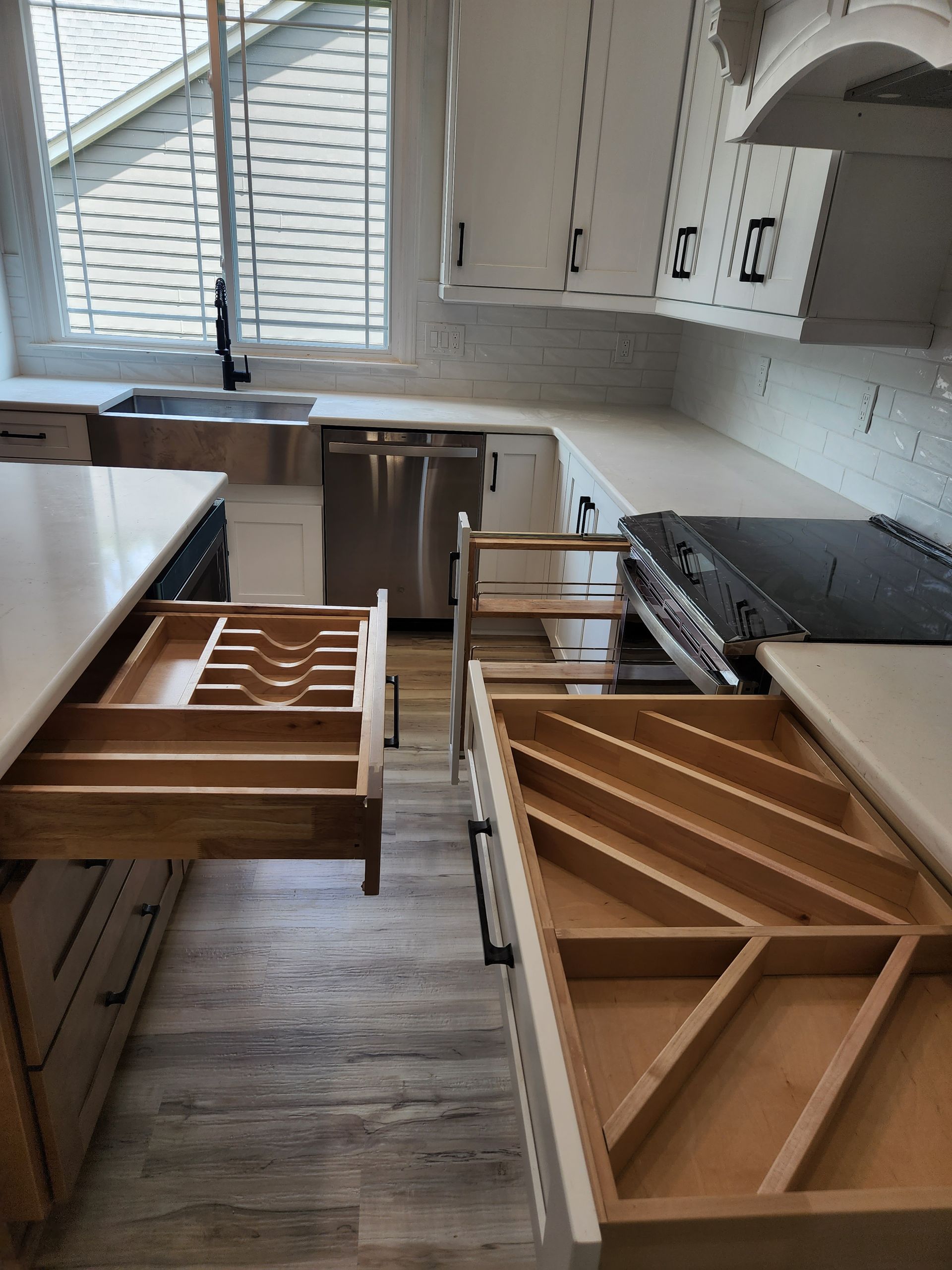 A kitchen with wooden drawers and a stove top oven
