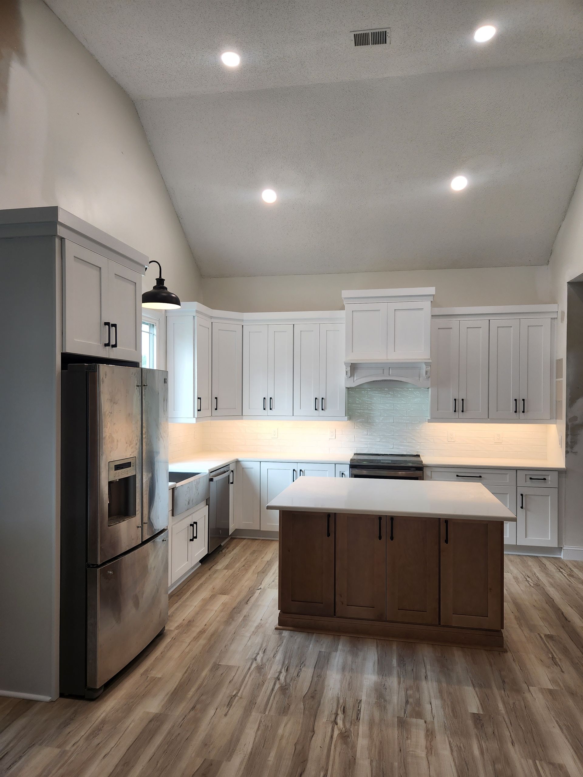 A kitchen with white cabinets and stainless steel appliances