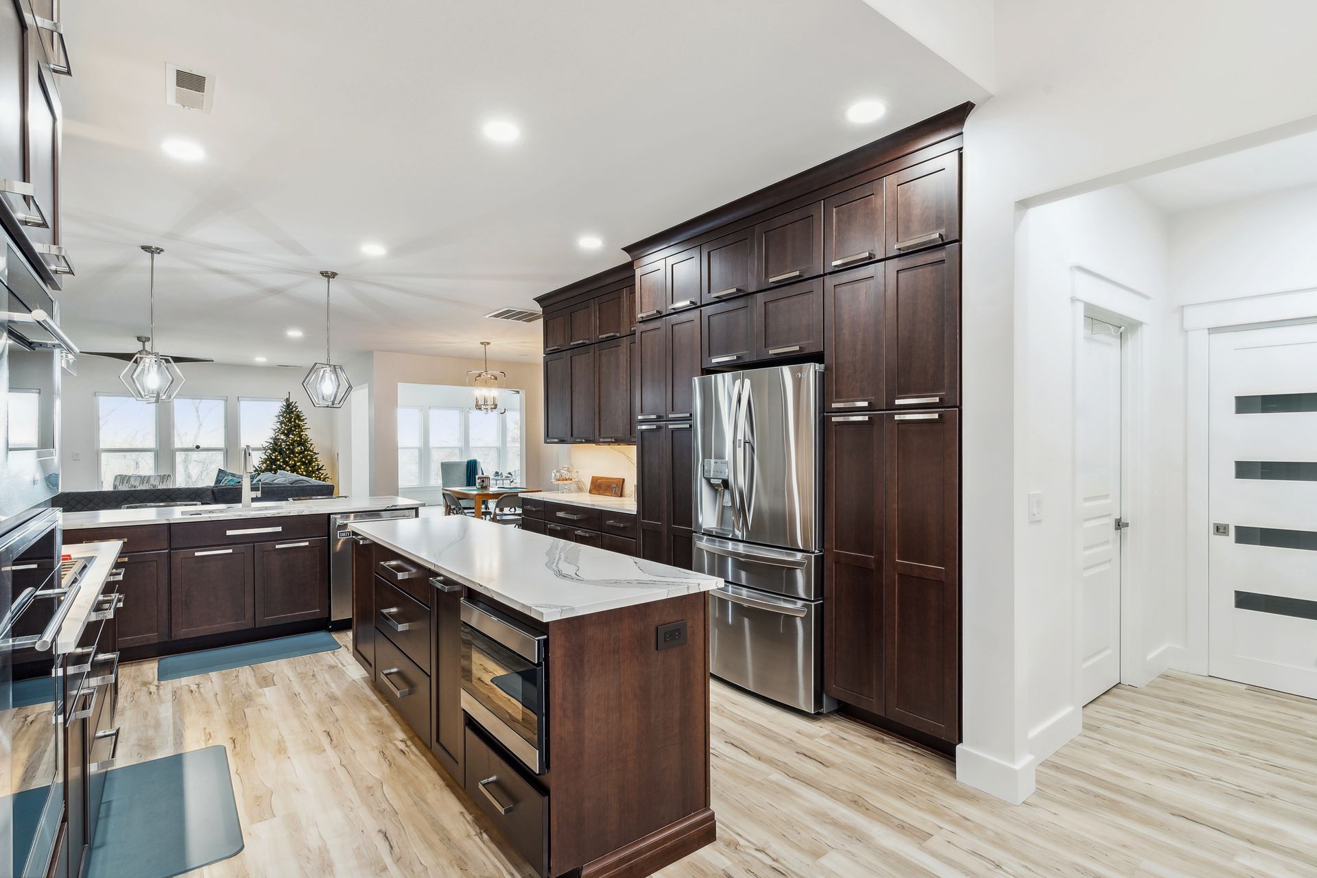 A kitchen with stainless steel appliances and wooden cabinets.