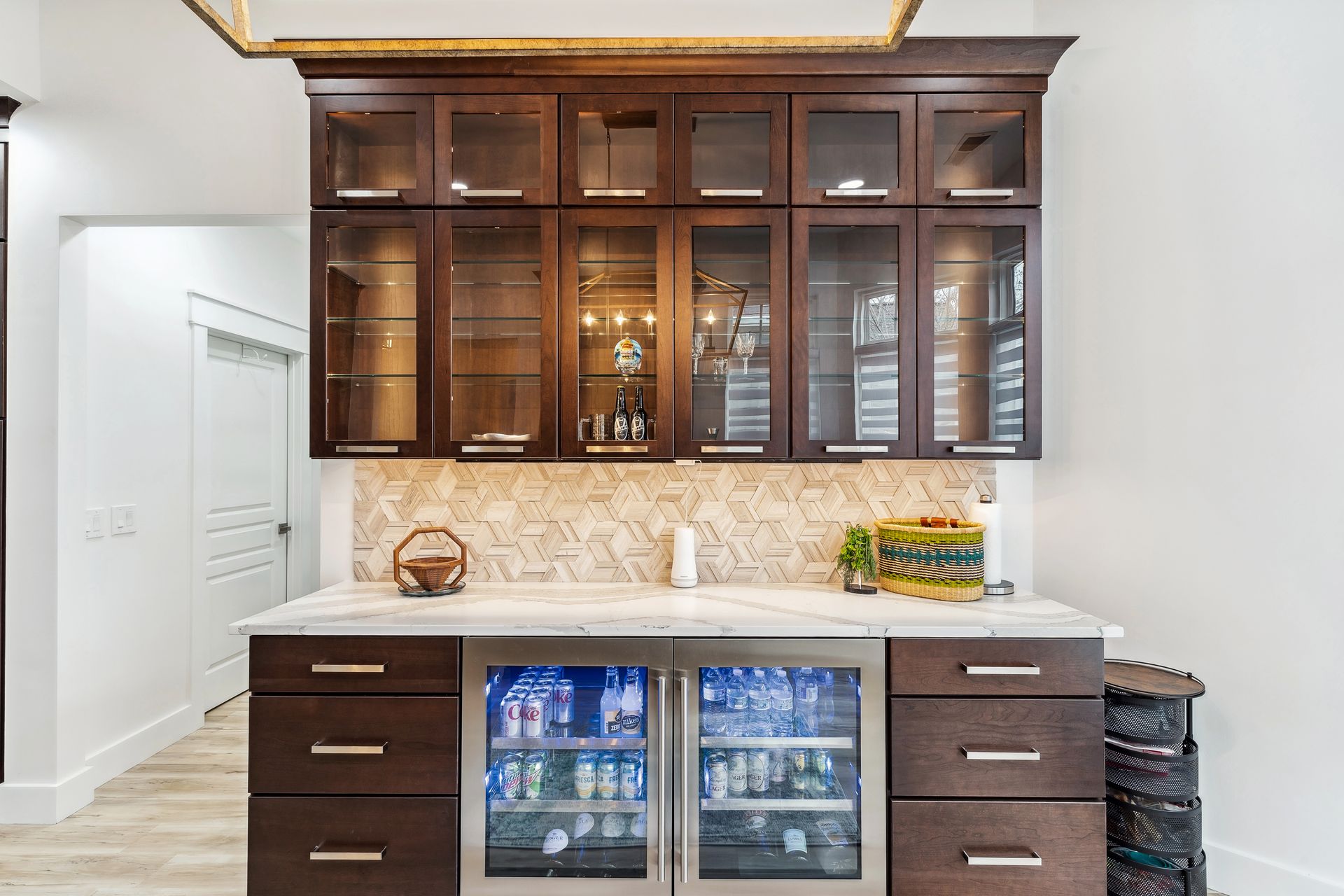 A kitchen with a bar and a refrigerator.