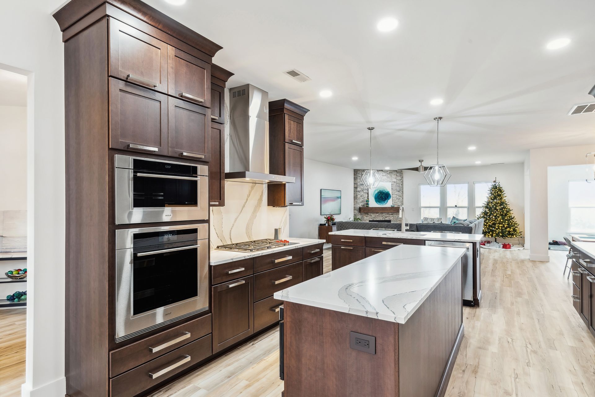 A kitchen with stainless steel appliances, wooden cabinets, and a large island.