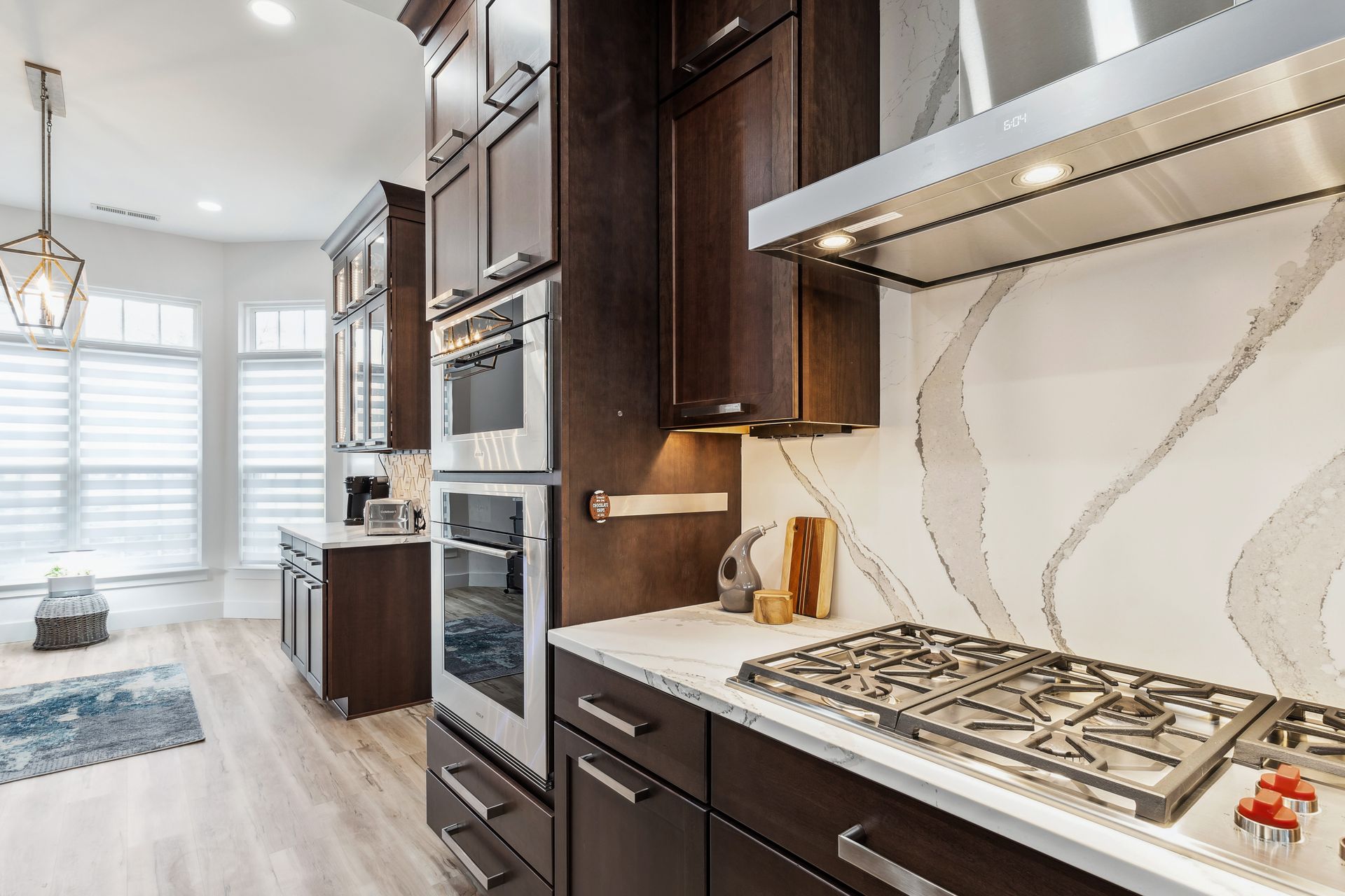 A kitchen with stainless steel appliances and wooden cabinets.